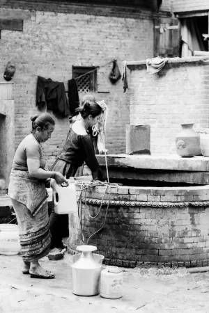 Women drawing water from well