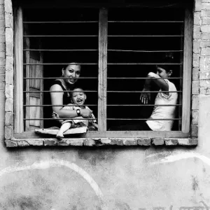 Mother and kids relaxing by window