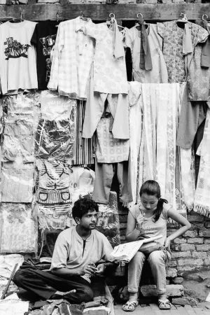 Man and woman selling clothes on street