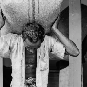 Man with a big hemp sack on his back