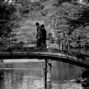 Couple crossing bridge