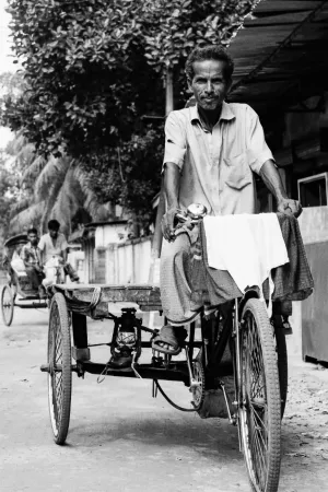 Man on tricycle with cargo bed