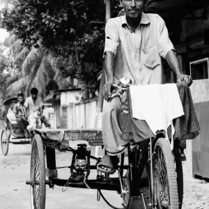 Man on tricycle with cargo bed