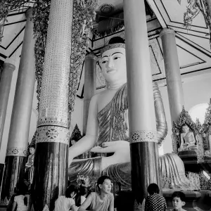 Father and son in front of Buddha statue