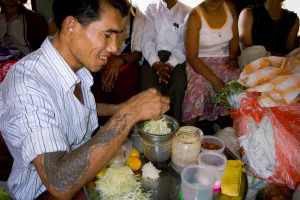 Man selling papaya salad