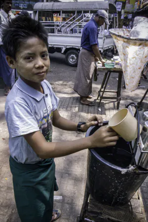 Boy selling drinking water by roadisde
