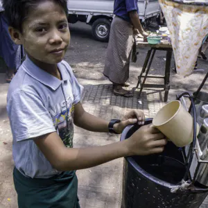 Boy selling drinking water by roadisde