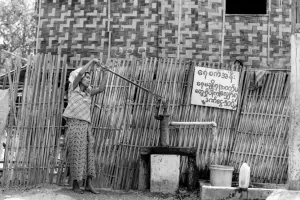 Woman drawing water from a well