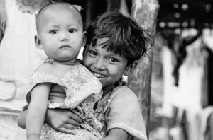 Girl embracing baby