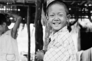 Boy pressing against pillar