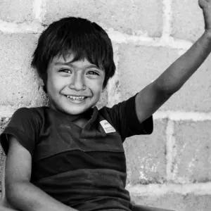 Boy smiling and raising arm