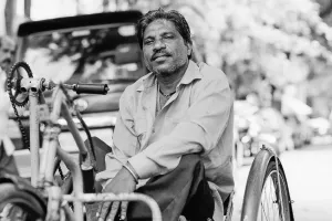 Man in a three-wheeled wheelchair