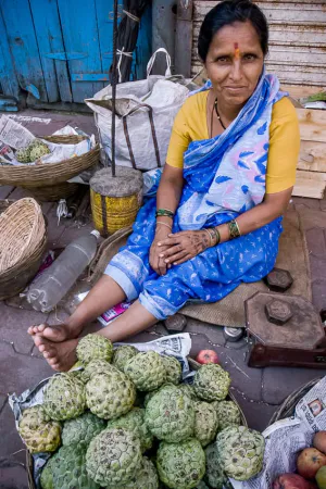 Woman selling both sugar apples and apples