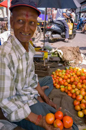 Old man with Tilaka selling tomatoes