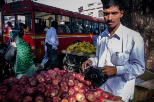 Man selling apples in bus terminal