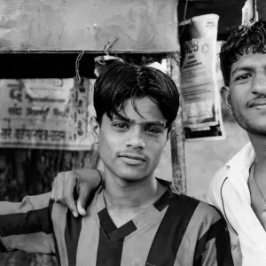 Two men in chai stand