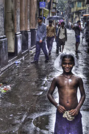 Boy standing in rain
