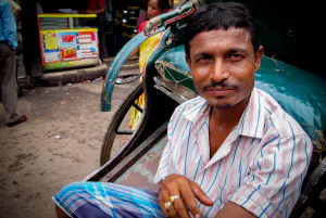 rickshaw wallah wearing striped shirt