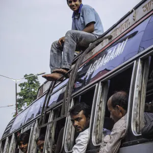 Young man on roof of bus