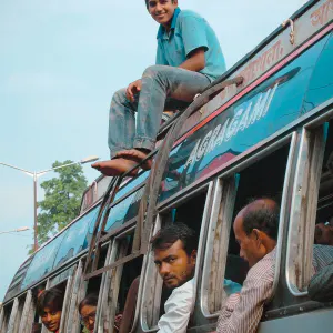 Young man on roof of bus