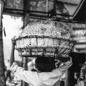 Man carrying big basket on head