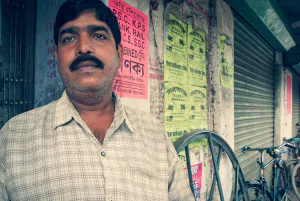 Man with thick body hair standing against wall