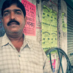 Man with thick body hair standing against wall