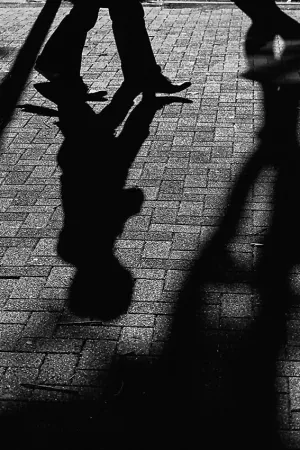 Shadows of pedestrian on ground