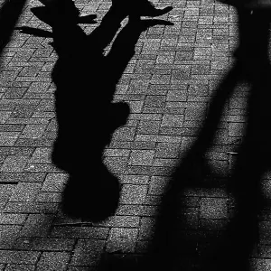 Shadows of pedestrian on ground