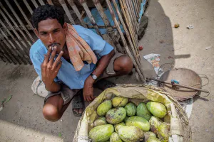 Mango seller resting and smoking