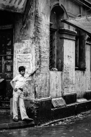 Young man standing in corner of street