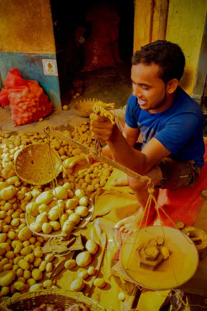 Man weighing potatoes