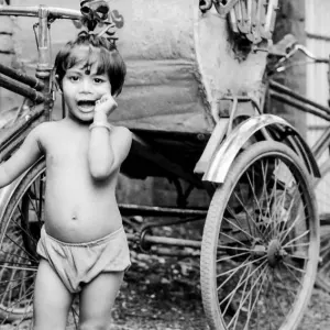 Little girl beside cycle rickshaw