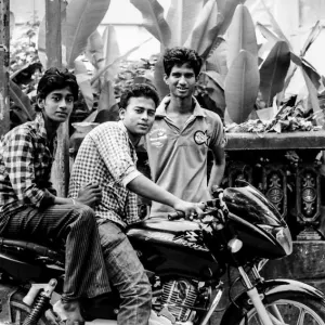 Three men around motorbike