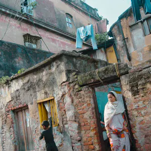 Woman and boy standing in front of a house