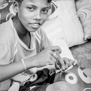 Boy sewing cushion