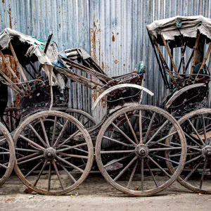 Battered rickshaw parked by roadside