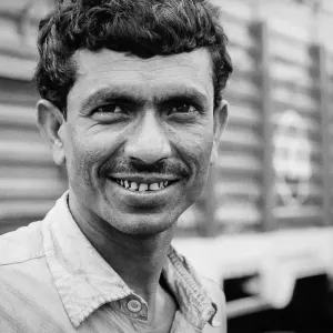 man smiling next to a truck