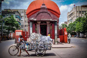 Tricycle with luggage carrier in front of Hindu hall