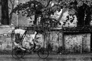 Cycle rickshaw running in rain