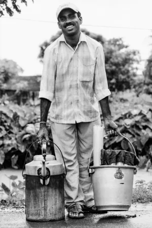 Man carrying bucket and kettle