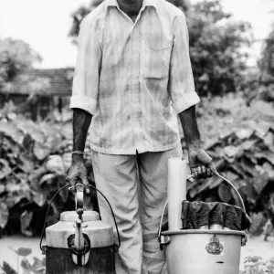 Man carrying bucket and kettle