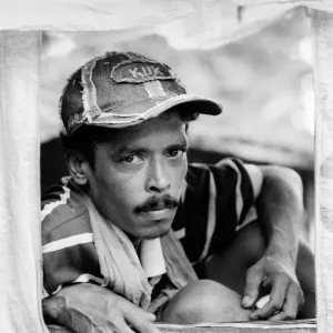 Rickshaw wallah wearing cap