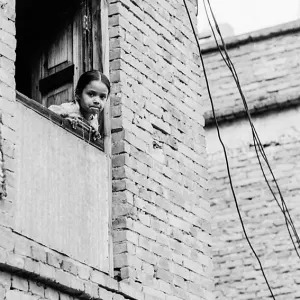 Girl leaning out from window