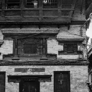 Man and boy in front of traditional house