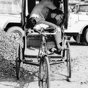 Rickshaw wallah sleeping on his rickshaw