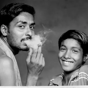 Smoking man and smiling boy