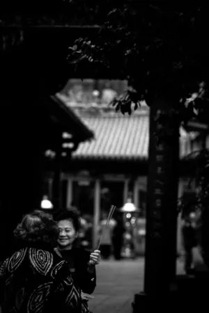Two women standing talking in Longshan Temple