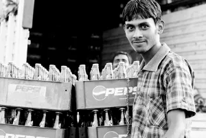 Man standing beside beverage bottles