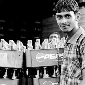 Man standing beside beverage bottles